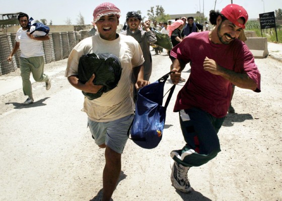 Former prisoners smile after being released from the Abu Ghraib prison in Baghdad. About 400 detainees were released Monday.