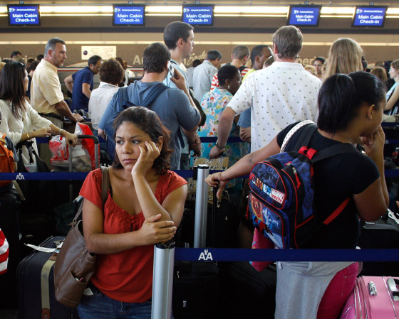 Image: Customers wait in line after a computer glitch at JFK