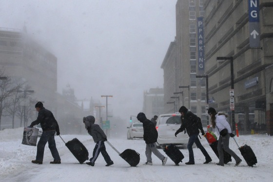 Image: Travelers leave Back Bay train and subway station during winter nor'easter snow storm in Boston