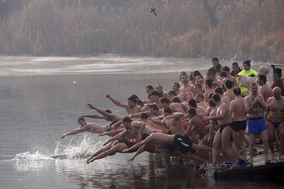 Bulgarians dive into the icy waters of a lake to catch a cross in Sofia as part of Epiphany Day celebrations on January 6, 2014. It is believed that the first man to grab the cross, thrown into the water by an Eastern Orthodox priest, will be healthy throughout the year.
