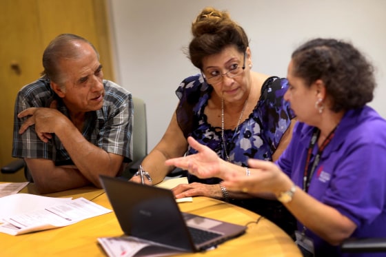 Image: Health navigator Nini Hadwen speaks with Jorge Hernandez and Marta Aguirre