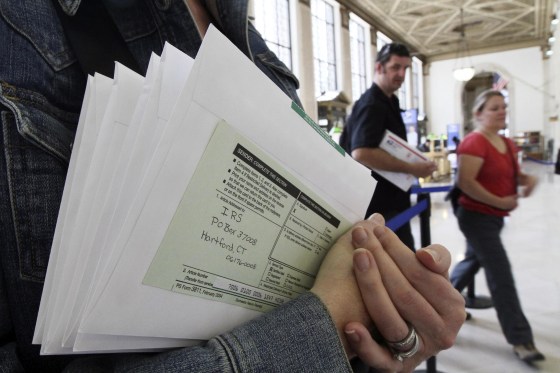 A woman waits to send her taxes at post office in New York.