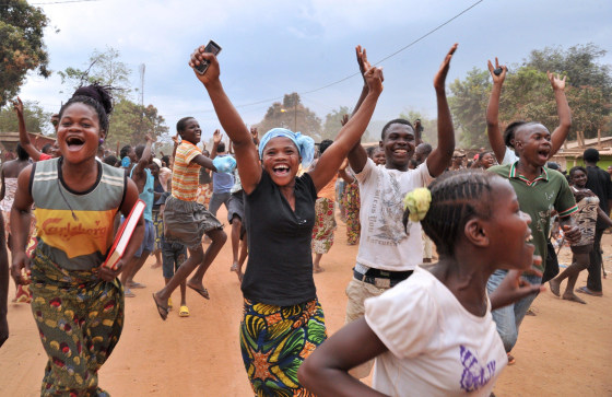 Residents of Bangui celebrate after former Seleka rebels were escorted out of Kasai military camp in Bangui to another camp outside the city on January 28, 2014. The UN Security Council will threaten sanctions on January 28 against the ringleaders of deadly turmoil in the Central African Republic and give a mandate to EU troops bolstering international forces there. The French-drafted resolution, expected to be adopted unanimously by the 15-nation council, also steps up pressure on interim President Catherine Samba Panza to restore order. AFP PHOTO / ISSOUF SANOGO ISSOUF SANOGO/AFP/Getty Images