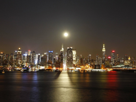 Image: A full moon rises over New York City above 42nd Street, as seen across the Hudson River in Weehawken, NJ.