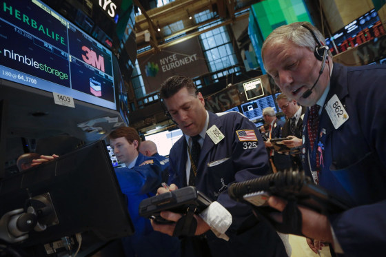 Image: Traders work on the floor of the New York Stock Exchange