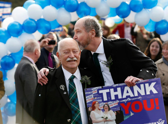 Image: Larry Lamont and Jerry Slater take part in a symbolic same-sex marriage outside the Scottish Parliament in Edinburgh