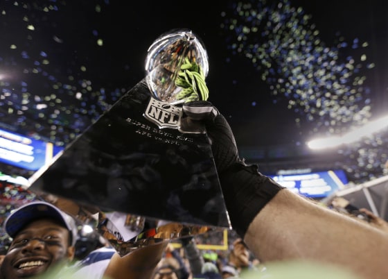 Image: Seattle Seahawk players celebrate with the Vince Lombardi trophy after defeating the Denver Broncos in the NFL Super Bowl XLVIII in East Rutherford