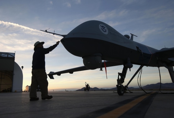 Maintenence personel check a Predator drone operated by U.S. Office of Air and Marine, before its surveillance flight near the Mexican border on March 7, 2013 from Fort Huachuca in Sierra Vista, Arizona.