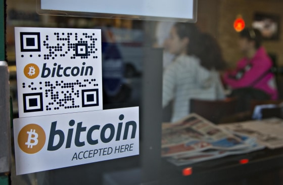 Signs on window advertise a bitcoin ATM machine that has been installed in a Waves Coffee House in Vancouver, British Columbia.