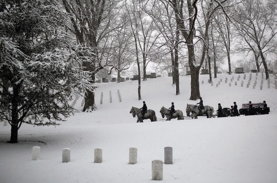 ARLINGTON, VA - FEBRUARY 25: A burial team leads a horse drawn caisson through a snow covered Arlington National Cemetery on February 25, 2014 in Arlington, Virginia. The Washington DC area received about an inch of snow this morning, adding to an already significant total for the winter. (Photo by Win McNamee/Getty Images)