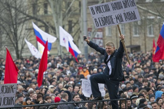 Pro-Russian protesters with Russian flags take part in a rally in central Donetsk in eastern Ukraine on Saturday. The banner reads, "In Russia, we have brothers, In Europe, we are slaves." 