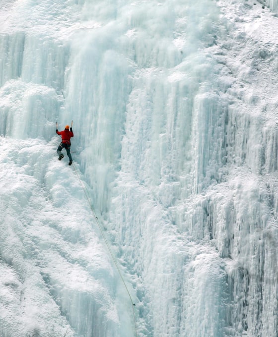 Image: An ice climber makes his way up Frankenstein Cliff in Hart's Location, N.H.