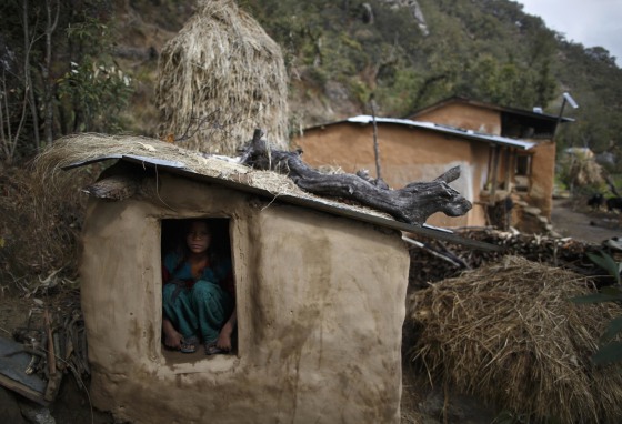 Image: Uttara Saud sits inside a Chaupadi shed in the hills of Legudsen village in Achham District in western Nepal