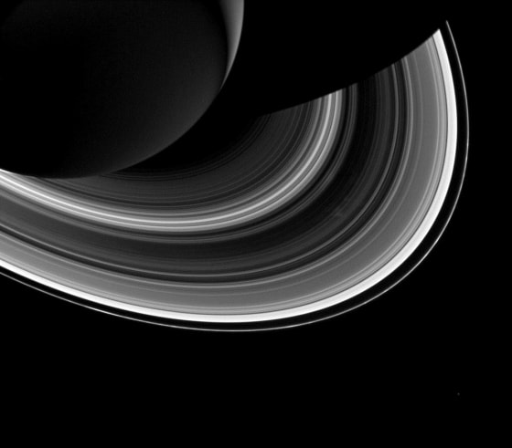 Among the interplay of Saturn's shadow and rings, Mimas, which appears in the lower-right corner of the image, orbits Saturn as a set of the ever-intriguing spokes appear in the B ring (just to the right of center).