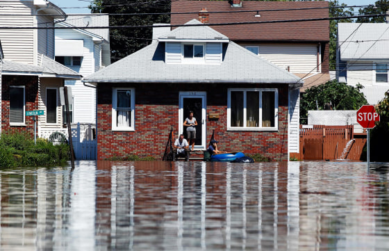 Image: Residents wait for flooding to subside in the town of Totowa, N.J.