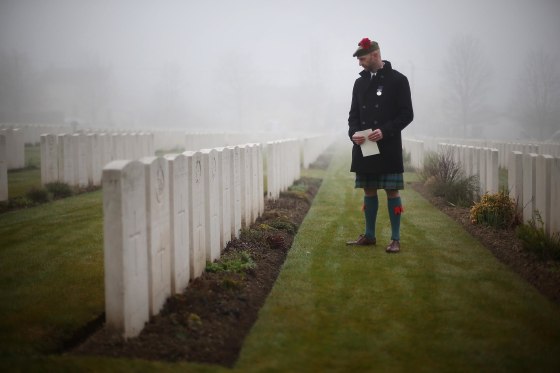 Image: Stephen McLeod, great step nephew of World War One soldier Private William McAleer, looks at headstones before a reburial ceremony at Loos British Cemetery