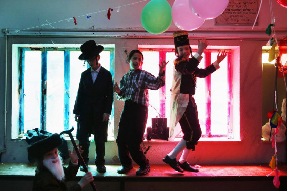 Image: Ultra Orthodox Jewish children dressed in costumes celebrate Purim in Jerusalem's Mea Shearim neighbourhood