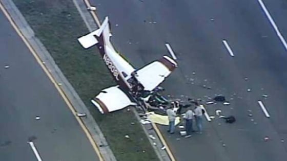 Officials investigate the scene of a single-engine plane crash in Pinellas County, Fla., on March 22, 2014. The pilot was killed and two passengers were injured.