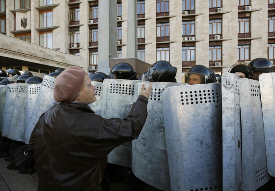 Image: A pro-Russian protester argues with riot policemen in Donetsk
