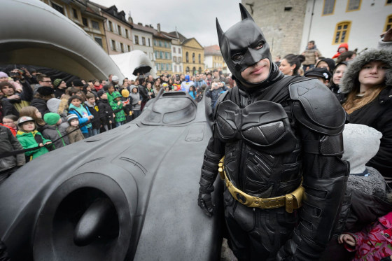 Image: A man disguised as Batman stands next to the Batmobile during the opening of the exhibition 'Superman, Batman & Co...mics' at the 'Maison d'Ailleurs' (lit: House of Elsewhere), museum