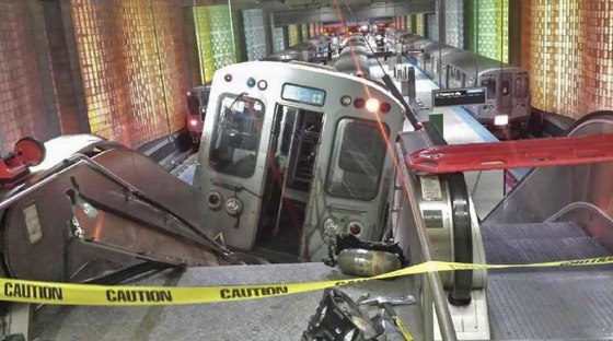 Image: A handout photo shows a derailed commuter train resting on an escalator at O'Hare international airport in Chicago