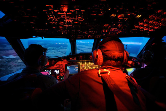 Image: Crew members on board an RAAF AP-3C Orion