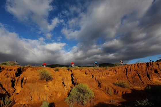 Image: Competitors ride through a dry river bed during the longest stage of the annual Absa Cape Epic mountain bike stage race near Cape Town, South Africa
