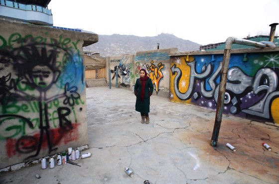 Image: Afghan artist Shamsia Hassani poses for a photograph on the roof of her graffiti workshop in Kabul