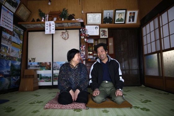 Image: A man and his wife, who evacuated from the Miyakoji area of Tamura three years ago, smile after they returned to their home in Tamura, Fukushima prefecture