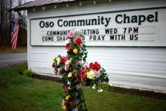 Image: A flower cross memorial is set up outside the Oso Community Chapel for mudslide victims in Oso