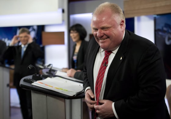 Mayor Rob Ford laughs during a commercial break as he takes part in a live television mayoral debate in Toronto on Wednesday, March 26, 2014.