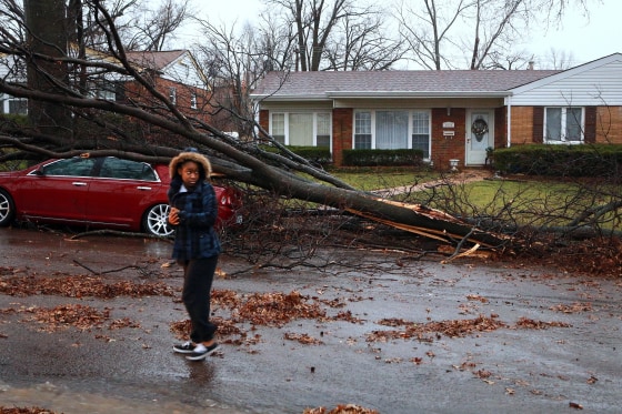 Tyann Scales, 14, walks through her neighborhood to see the damage after a tornado touched down briefly in the St. Louis area on April 3.