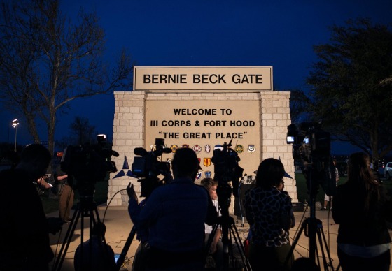 Image: The media and Public Affairs military personnel wait for a press conference to be held outside the Bernie Beck Gate