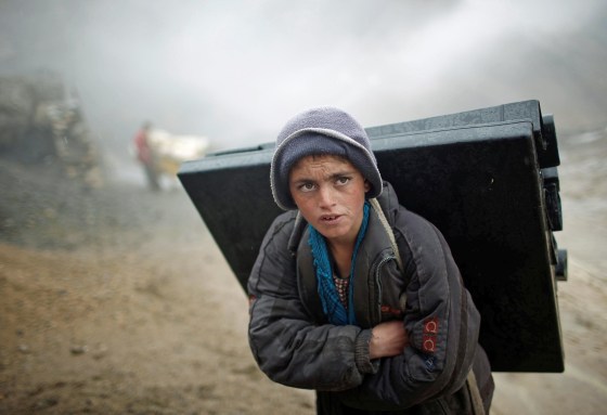 An Afghan boy carries election material on his back to polling stations which are not accessible by road in Shutul, Panjshir province, on April 4.