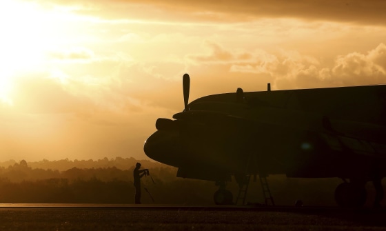 Image: A ground crewman stands in front of a South Korean P3 Orion after it returned from the search for missing Malaysia Airlines Flight MH370 in Perth, Australia