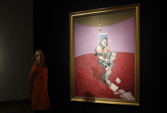 A gallery assistant poses with "Portrait of George Dyer Talking" by Francis Bacon in 1966 on display at Christie's in London February 7, 2014.