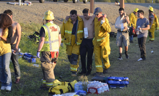 Image: Emergency personnel help a survivor after crash near Orland, Calif.