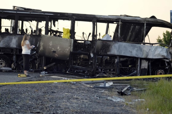 Image: California Highway Patrol officer Hoover surveys the wreckage at the scene of a collision of a tractor-trailer and a tour bus on Interstate 5 near Highway 32 near Orland