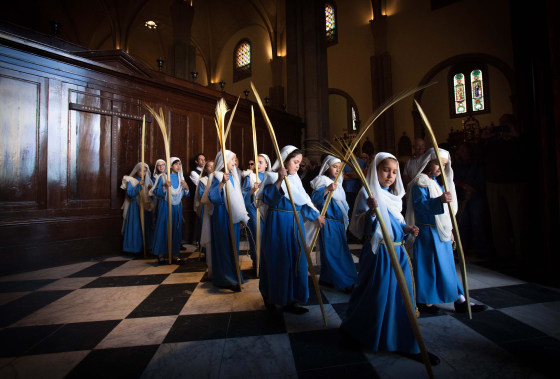 Image: People wave leaves during celebrations marking Palm Sunday