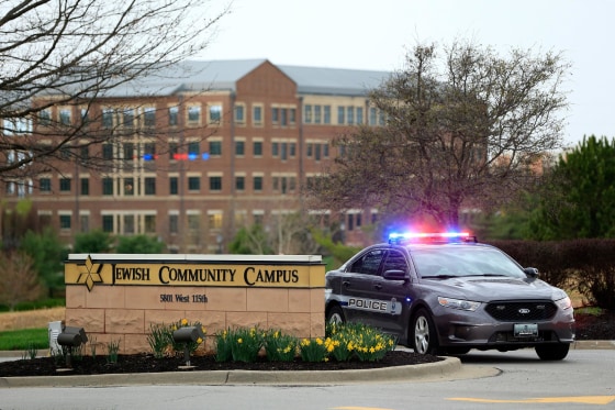 A police car sits at the entrance of the Jewish Community Center after three were killed when a gunman opened fire on April 13, 2014, in Overland Park, Kansas. Police arrested and were questioning a suspect. 