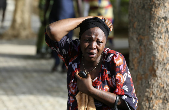 A bystander reacts as victims of a bomb blast arrive at the Asokoro General Hospital in Abuja, Nigeria, on Monday.