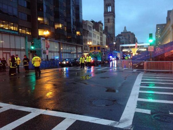 Image: Police stand near the finish line of the Boston Marathon, where unattended backpacks were found on Tuesday