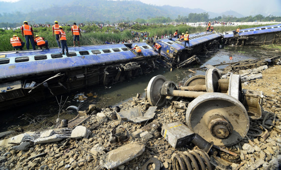 Railway workers inspect the derailed carriages of a passenger train at Jagiroad Railway Station, about 56 miles away from Guwahati, India, on April 16.