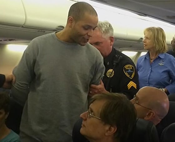 Image: Joshua Suggs is escorted off a Southwest Airlines flight.