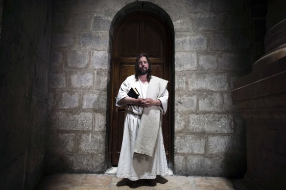 Image: Yakov, a Christian pilgrim from the U.S., poses for a photograph in the Church of the Holy Sepulchre in Jerusalem's Old City