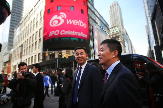 China's Weibo CEO Charles Chao walks in Times Square moments after Weibo began trading on the Nasdaq exchange under the ticker symbol WB.