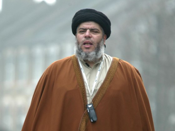 Radical Muslim cleric Mustafa Kamel Mustafa prays in a street outside his Mosque in north London on March 28, 2003.