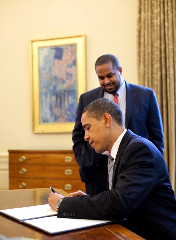 President Barack Obama signs the proclamation marking the National Day of Prayer May 7, 2009. Looking on is Joshua DuBois, Director of the White House Office for Faith-Based and Neighborhood Partnerships. Official White House Photo by Pete Souza