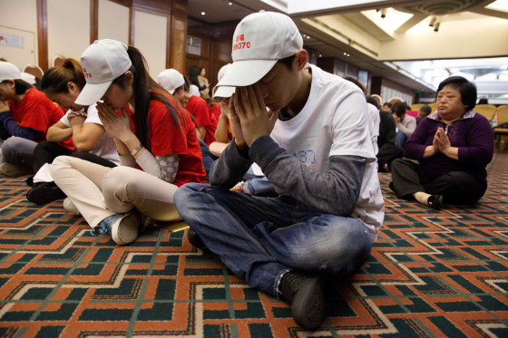 Image: Relatives of Chinese passengers on board Malaysia Airlines Flight 370 last month in Beijing.