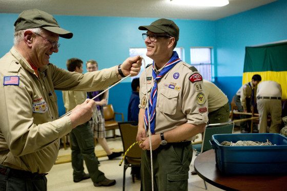 Scoutmaster Geoff McGrath, right, teaches knot tying to Troop Committee Member Donovan O'Brien at a troop meeting at Rainier Beach United Methodist Church in Seattle, Wash. on March 27.